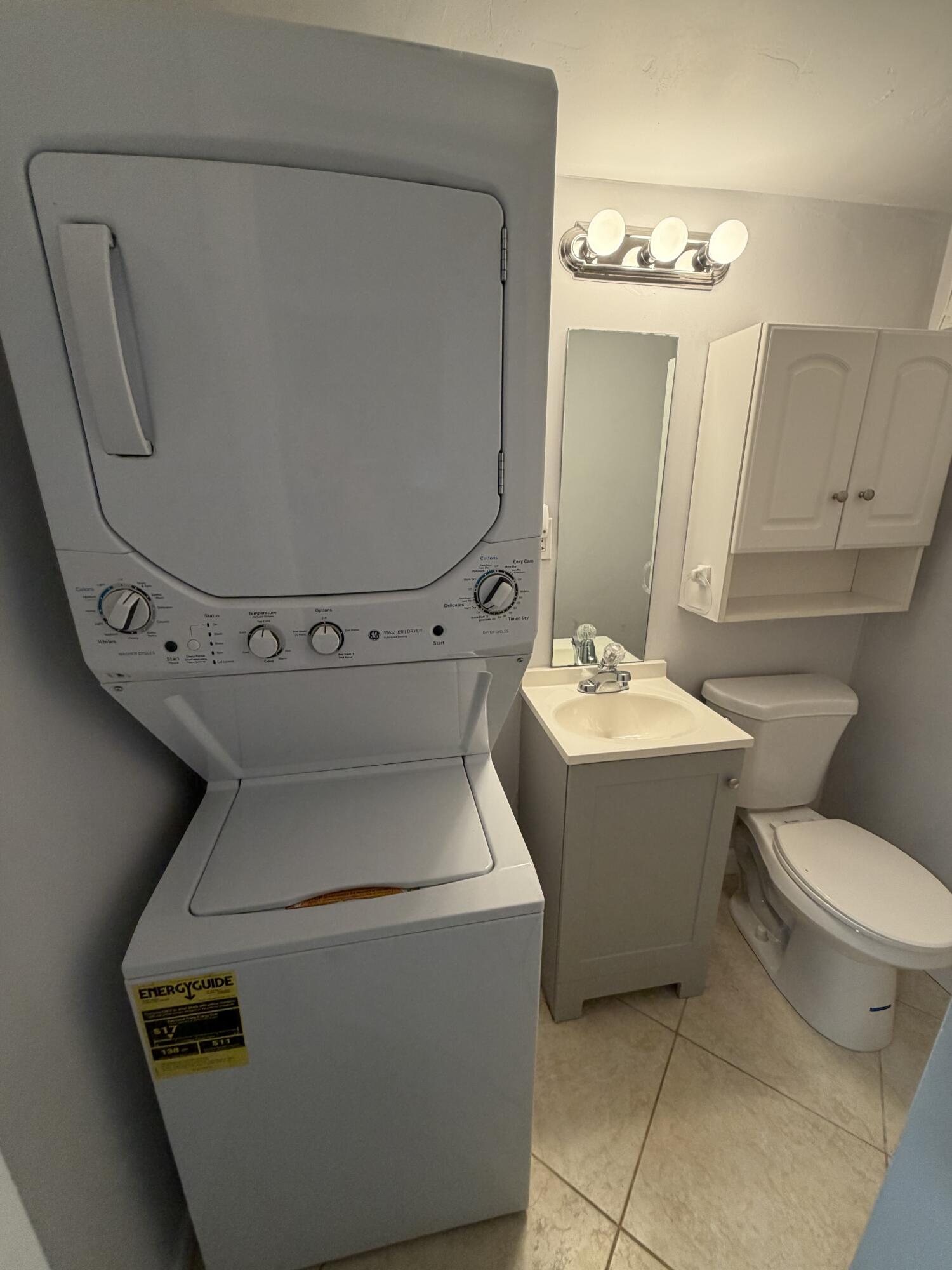 3225 Northeast 21st Avenue, Unit 7 Lighthouse Point, FL 33064 - Photo 20 of 28 a bathroom with a toilet sink and mirror