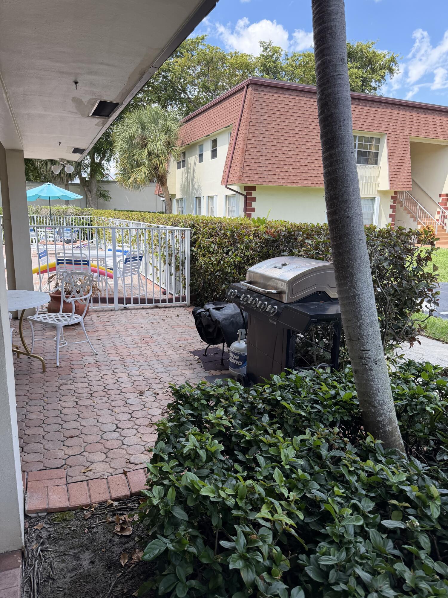 3225 Northeast 21st Avenue, Unit 7 Lighthouse Point, FL 33064 - Photo 22 of 28 a front view of a house with a yard