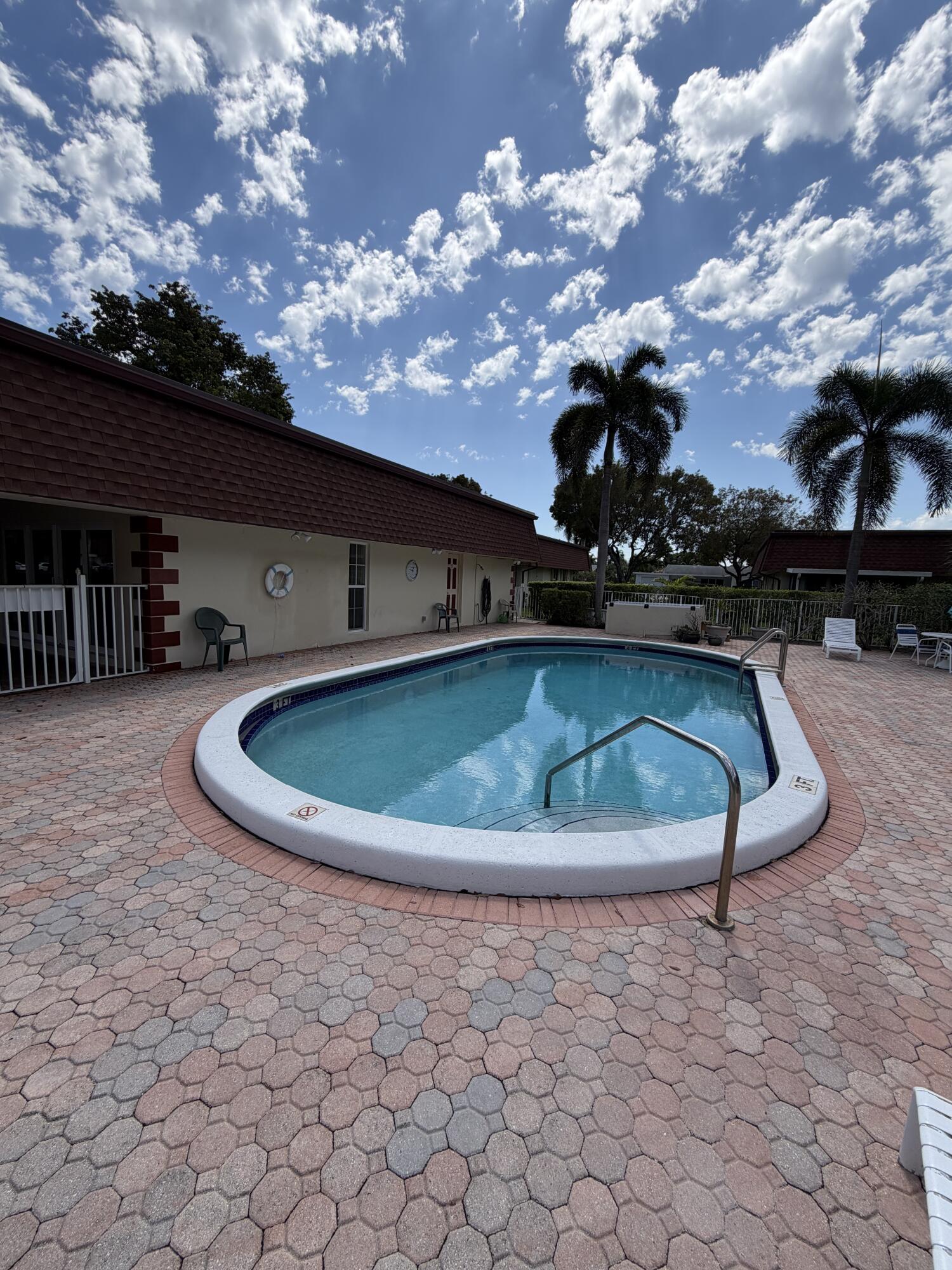 3225 Northeast 21st Avenue, Unit 7 Lighthouse Point, FL 33064 - Photo 24 of 28 a view of a swimming pool with a yard
