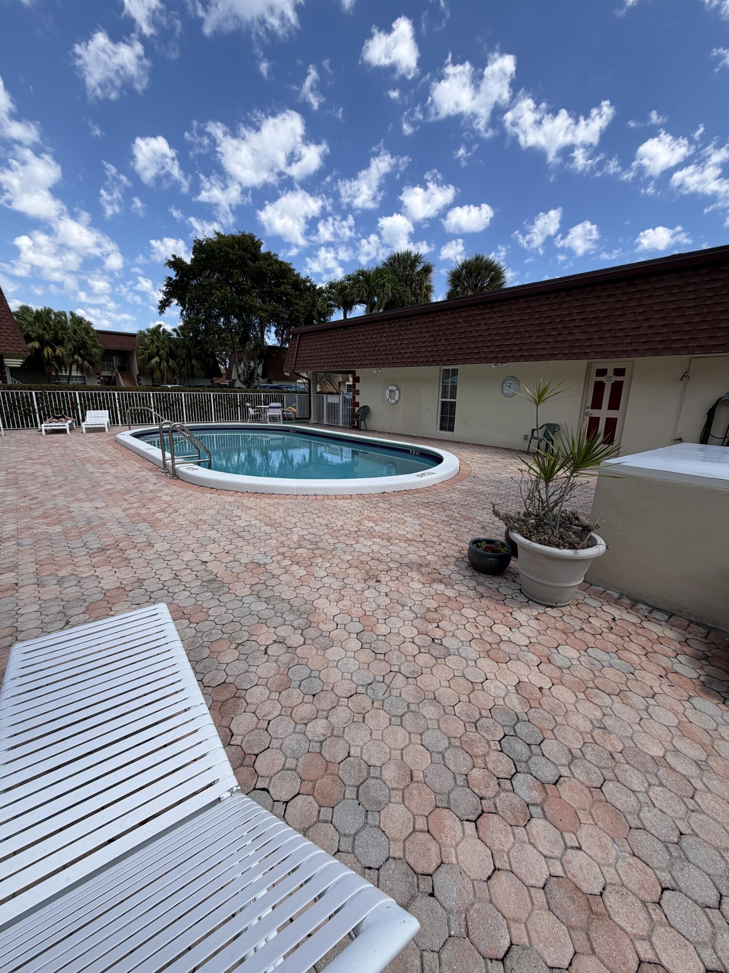 3225 Northeast 21st Avenue, Unit 7 Lighthouse Point, FL 33064 - Photo 25 of 28 a view of a backyard and a patio
