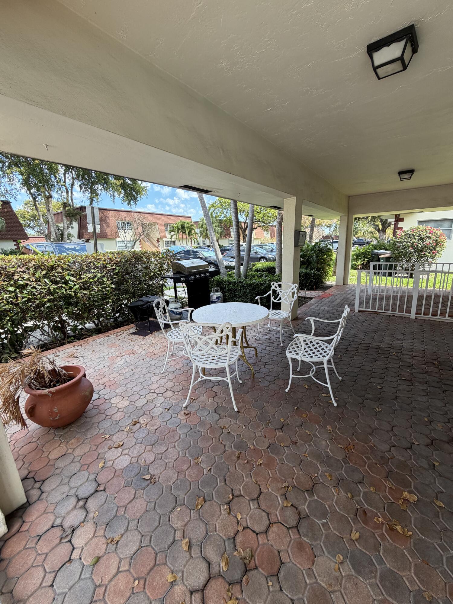 3225 Northeast 21st Avenue, Unit 7 Lighthouse Point, FL 33064 - Photo 26 of 28 a outdoor space with a couch and a potted plant