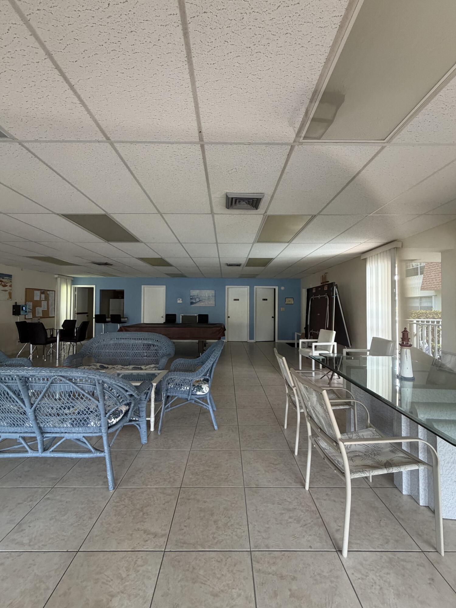 3225 Northeast 21st Avenue, Unit 7 Lighthouse Point, FL 33064 - Photo 27 of 28 a living room with furniture a flat screen tv and a table