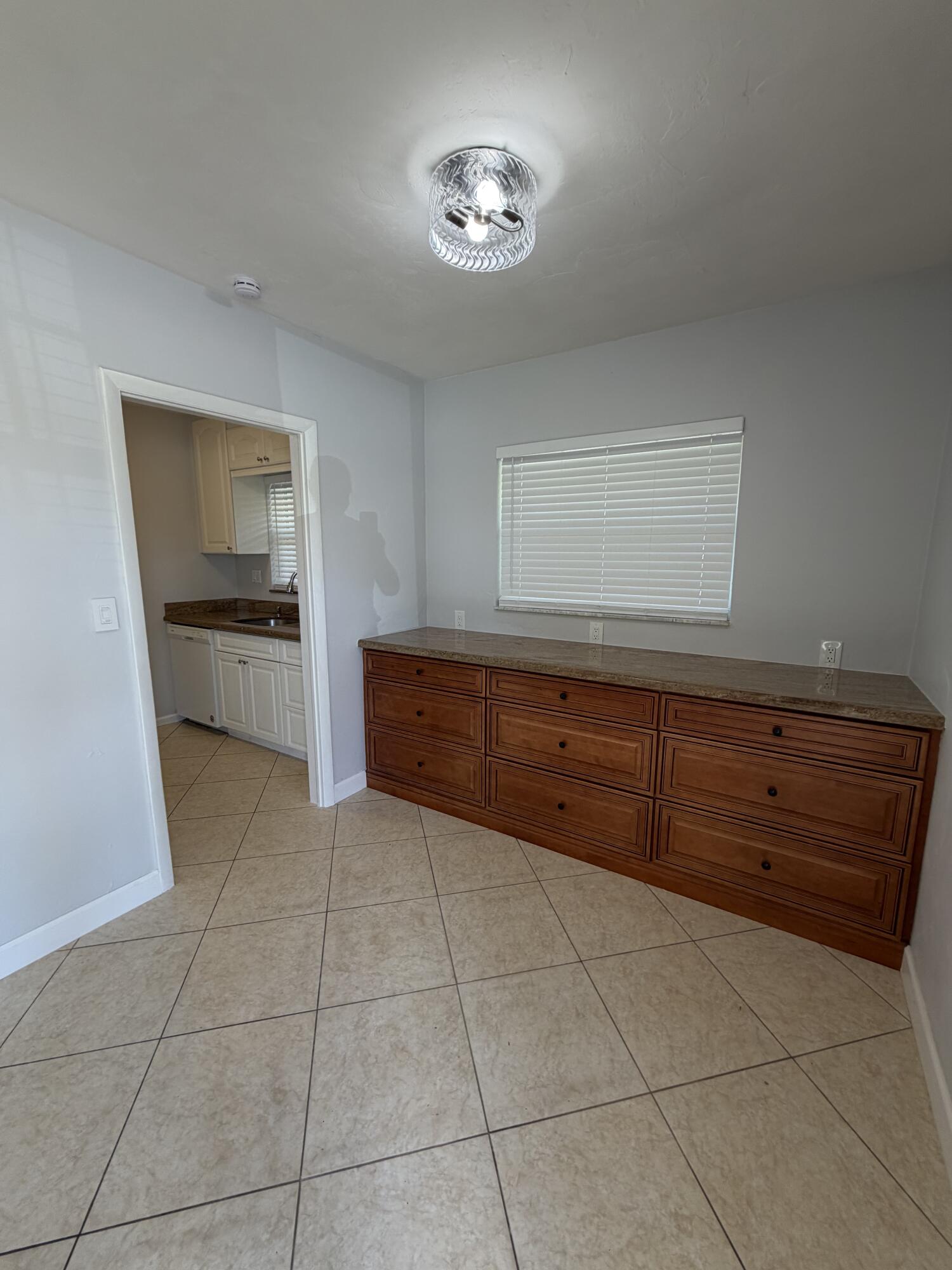 3225 Northeast 21st Avenue, Unit 7 Lighthouse Point, FL 33064 - Photo 9 of 28 a kitchen with a cabinets and fireplace