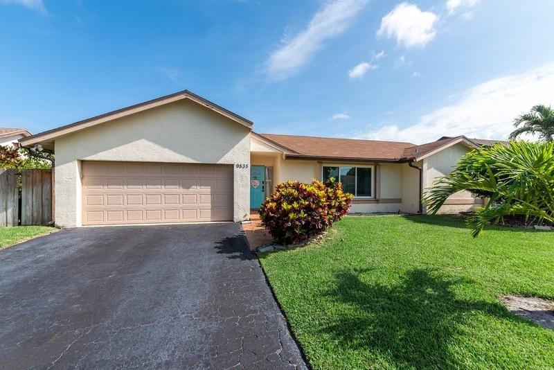9535 Ohio Place Boca Raton, FL 33434 - Photo 1 of 16 a front view of a house with garden