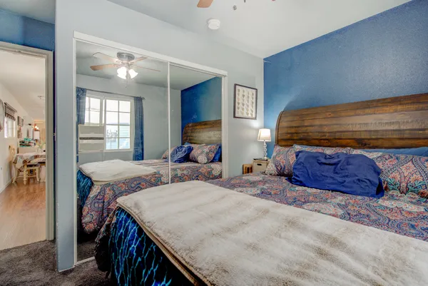 a bedroom with two beds and a dresser