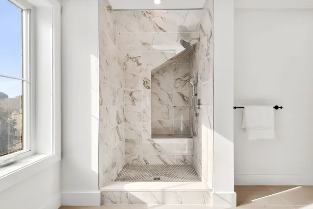 a bathroom with a glass shower door