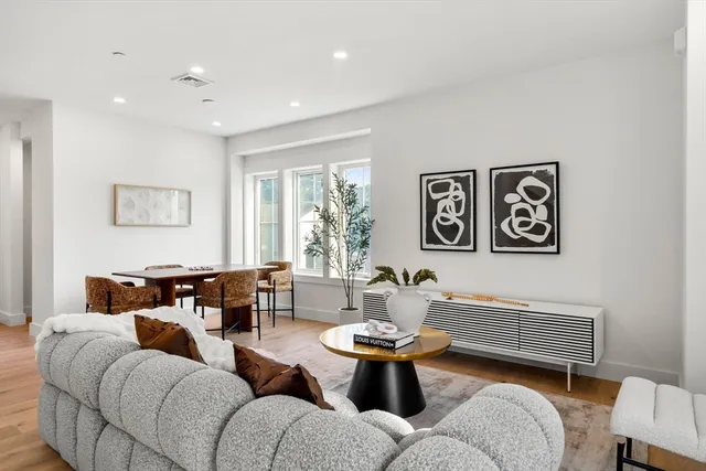 a living room with furniture a rug and a window