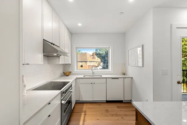 a kitchen with a sink cabinets and window
