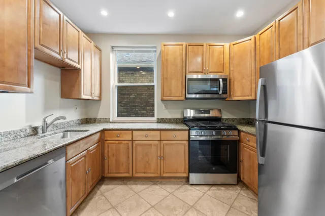 a kitchen with a sink stove and refrigerator
