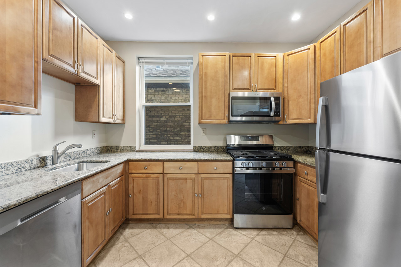 5728 North Maplewood Avenue Chicago, IL 60659 - Photo 12 of 30 a kitchen with a sink stove and refrigerator
