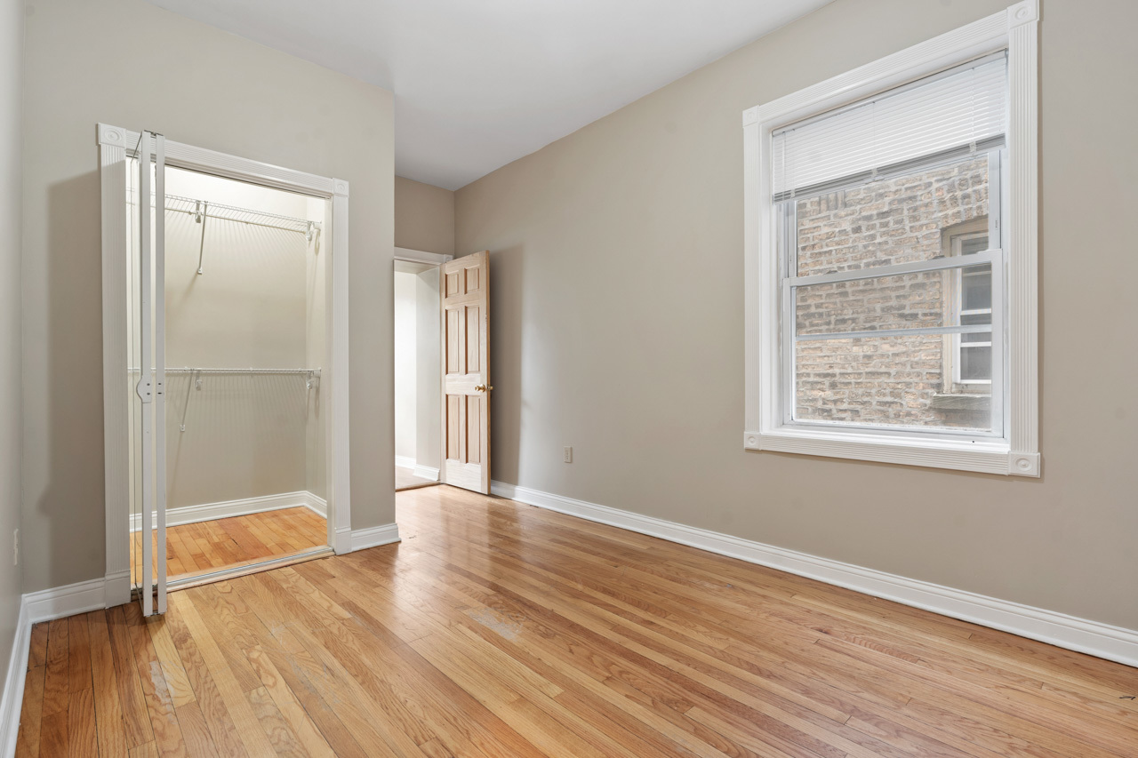 5728 North Maplewood Avenue Chicago, IL 60659 - Photo 16 of 30 an empty room with wooden floor and windows