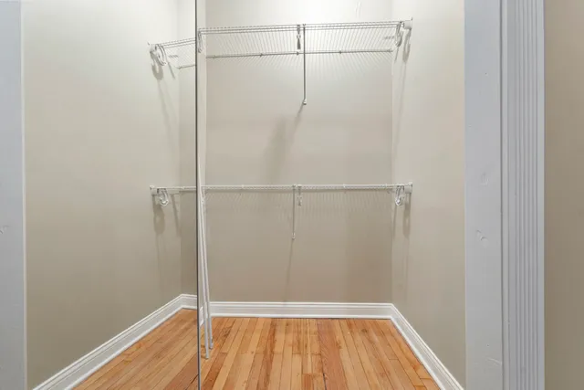 a view of a room with wooden floor and fan