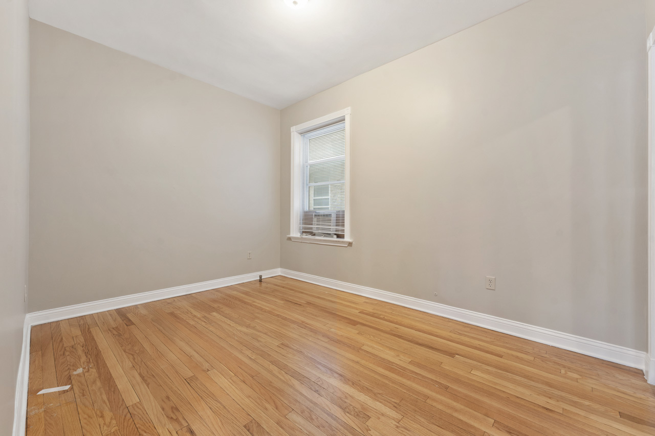 5728 North Maplewood Avenue Chicago, IL 60659 - Photo 19 of 30 an empty room with wooden floor and windows