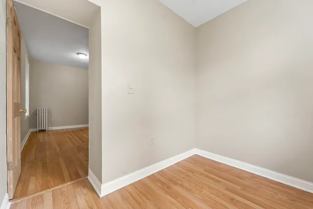 a view of hallway with wooden floor