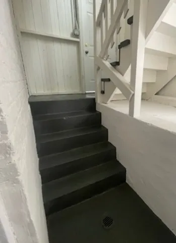 a view of a house with a garden and pathway