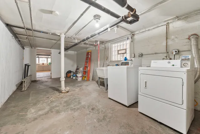 a view of storage and utility room with washer and dryer