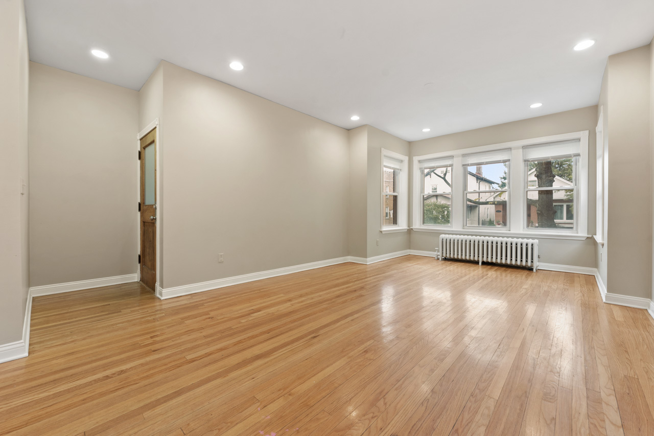 5728 North Maplewood Avenue Chicago, IL 60659 - Photo 7 of 30 a view of an empty room with a window and wooden floor