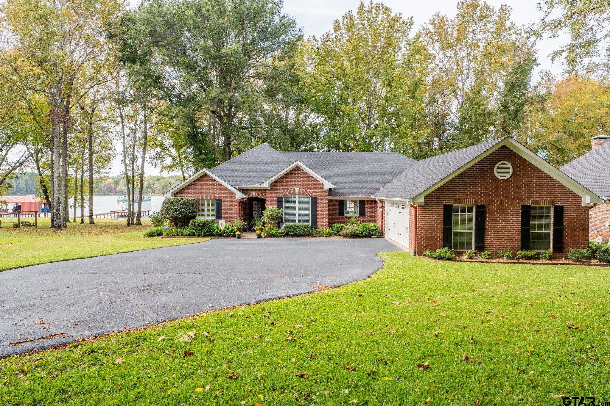 14312 East Ridge Road Arp, TX 75750 - Photo 1 of 44 a front view of a house with a yard and garage