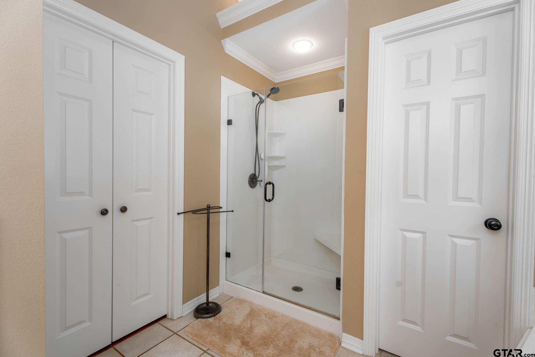 14312 East Ridge Road Arp, TX 75750 - Photo 18 of 44 a bathroom with a shower and a glass door