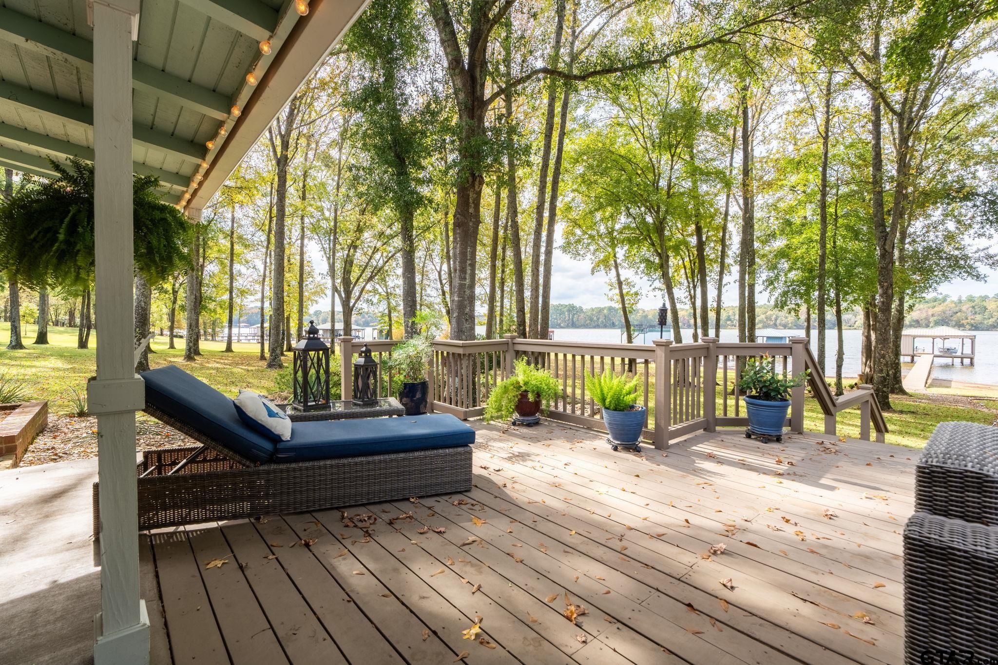 14312 East Ridge Road Arp, TX 75750 - Photo 25 of 44 a view of a deck with couches and wooden floor next to a yard