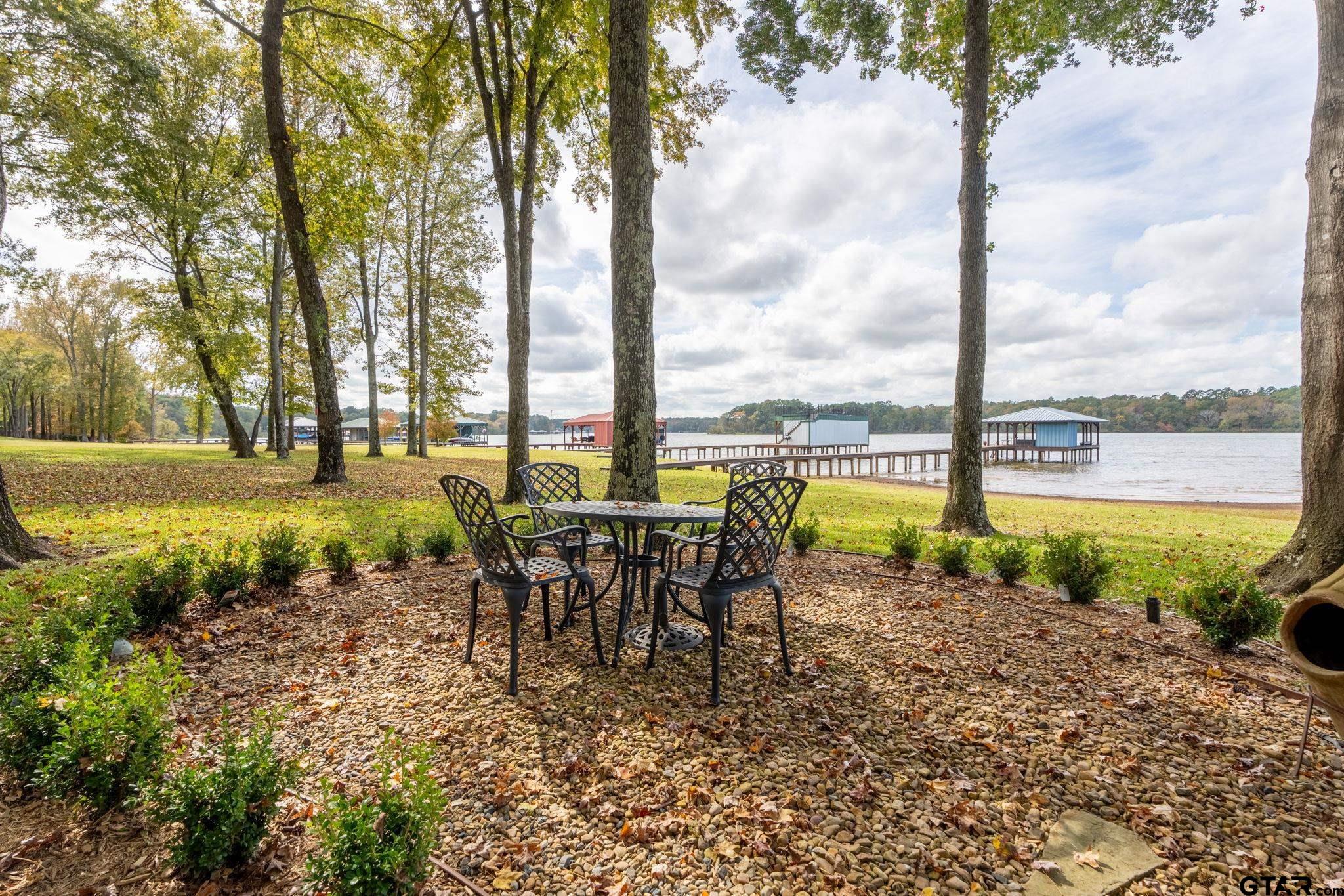 14312 East Ridge Road Arp, TX 75750 - Photo 31 of 44 a view of a lake with a table and chairs