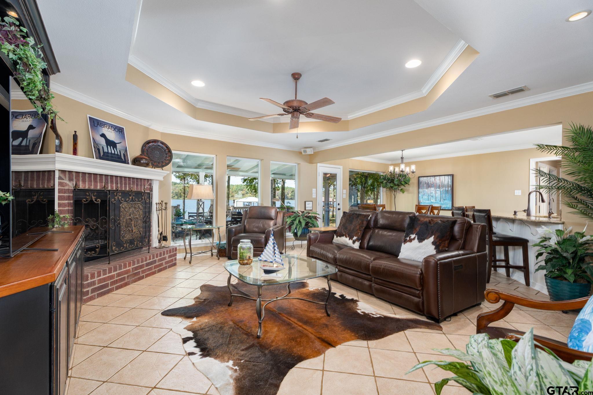 14312 East Ridge Road Arp, TX 75750 - Photo 6 of 44 a living room with furniture a fireplace and a chandelier