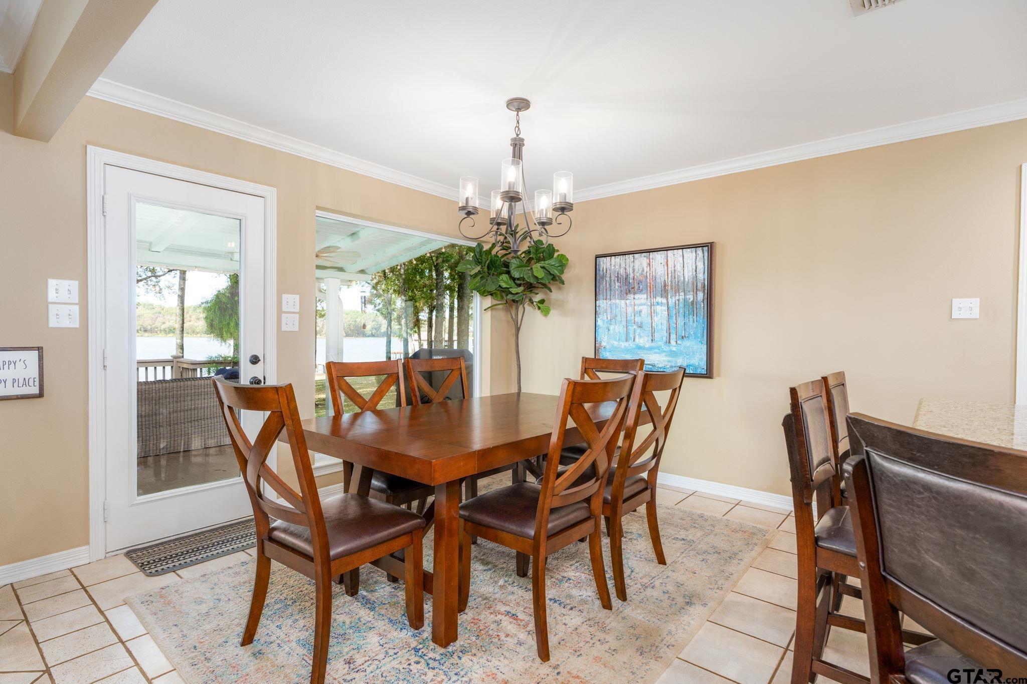 14312 East Ridge Road Arp, TX 75750 - Photo 8 of 44 a dining room with furniture a chandelier and wooden floor