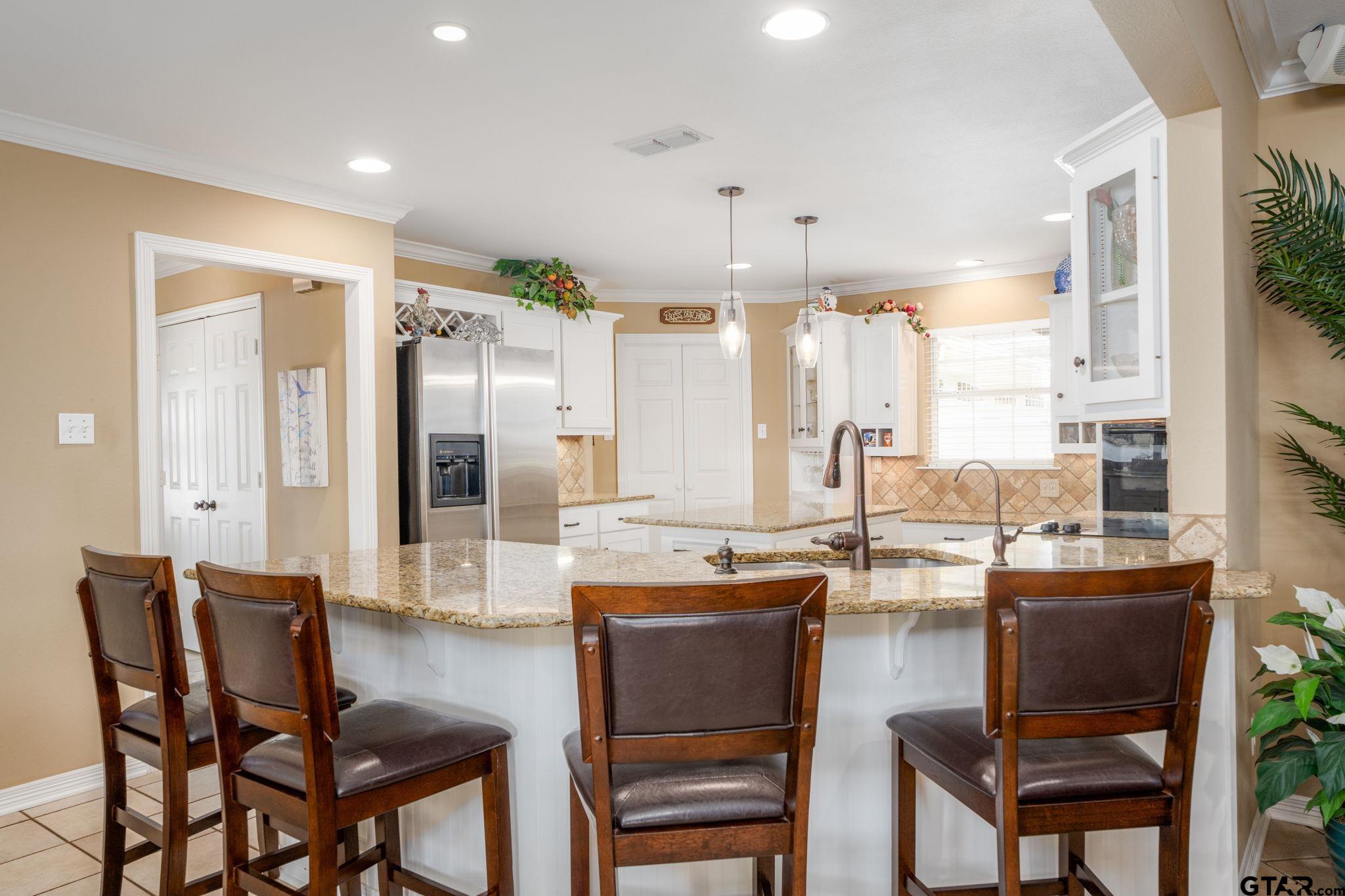 14312 East Ridge Road Arp, TX 75750 - Photo 9 of 44 a dining hall with stainless steel appliances granite countertop a table and chairs