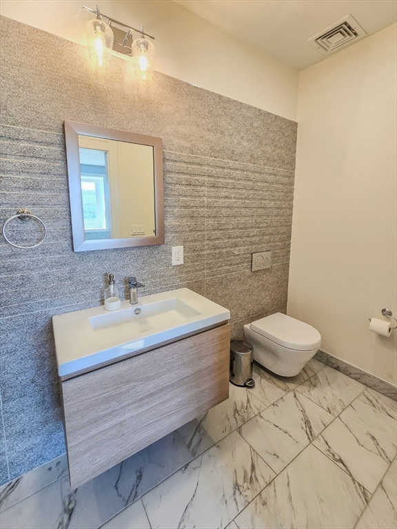 34 Dix Street, Unit 5 Boston, MA 02122 - Photo 11 of 23 a bathroom with a sink a toilet and mirror