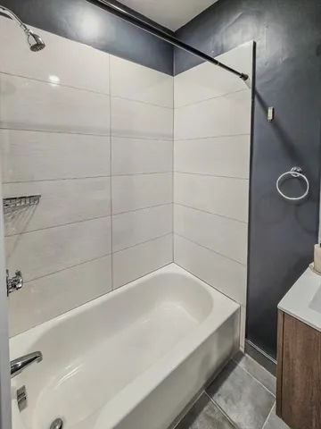 a view of room with window and wooden floor