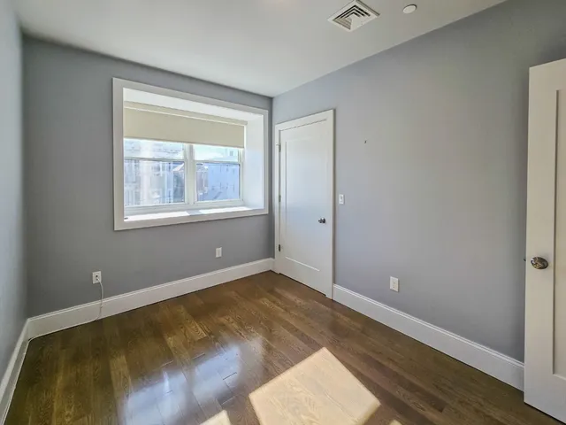 a view of a room with wooden floor
