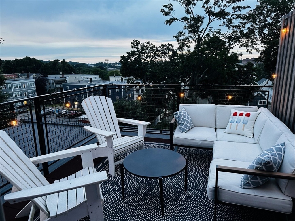 34 Dix Street, Unit 5 Boston, MA 02122 - Photo 19 of 23 a roof deck with couches and wooden floor