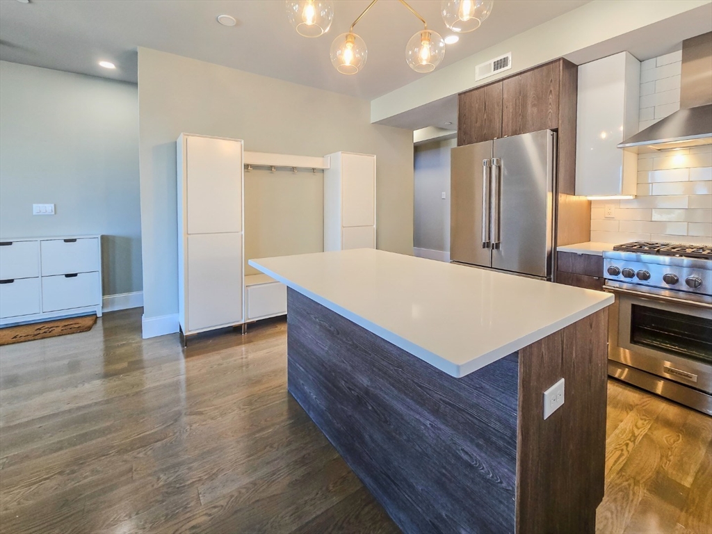 34 Dix Street, Unit 5 Boston, MA 02122 - Photo 2 of 23 a kitchen with kitchen island a sink appliances and cabinets