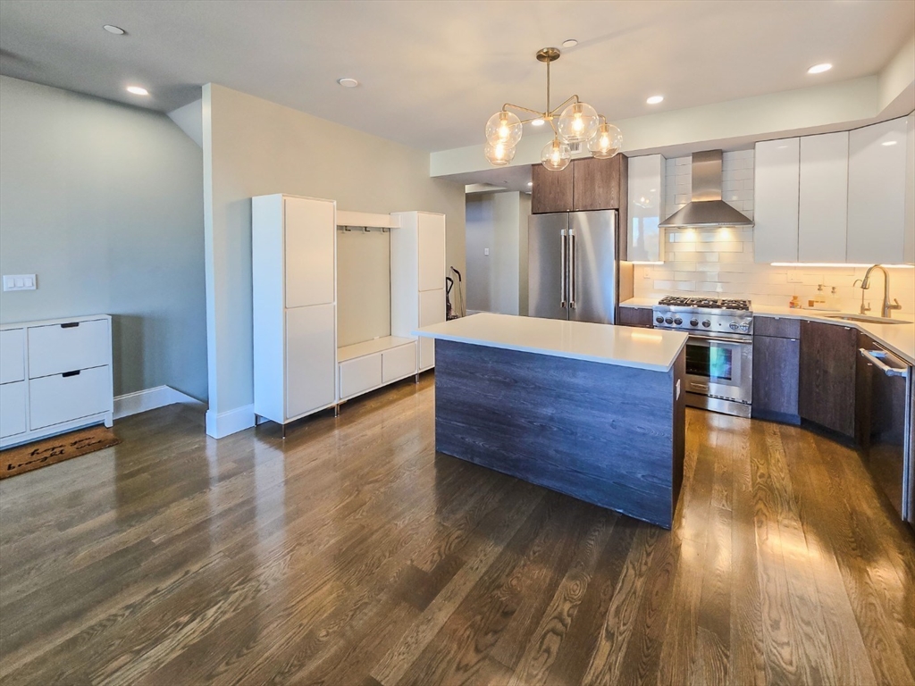 34 Dix Street, Unit 5 Boston, MA 02122 - Photo 3 of 23 an open kitchen with wooden floor and large cabinets