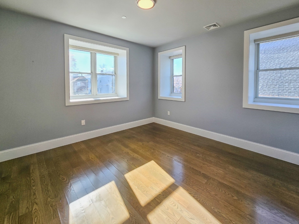 34 Dix Street, Unit 5 Boston, MA 02122 - Photo 9 of 23 a view of an empty room with wooden floor and a window