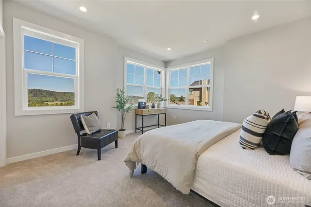 a bedroom with a bed and a chair