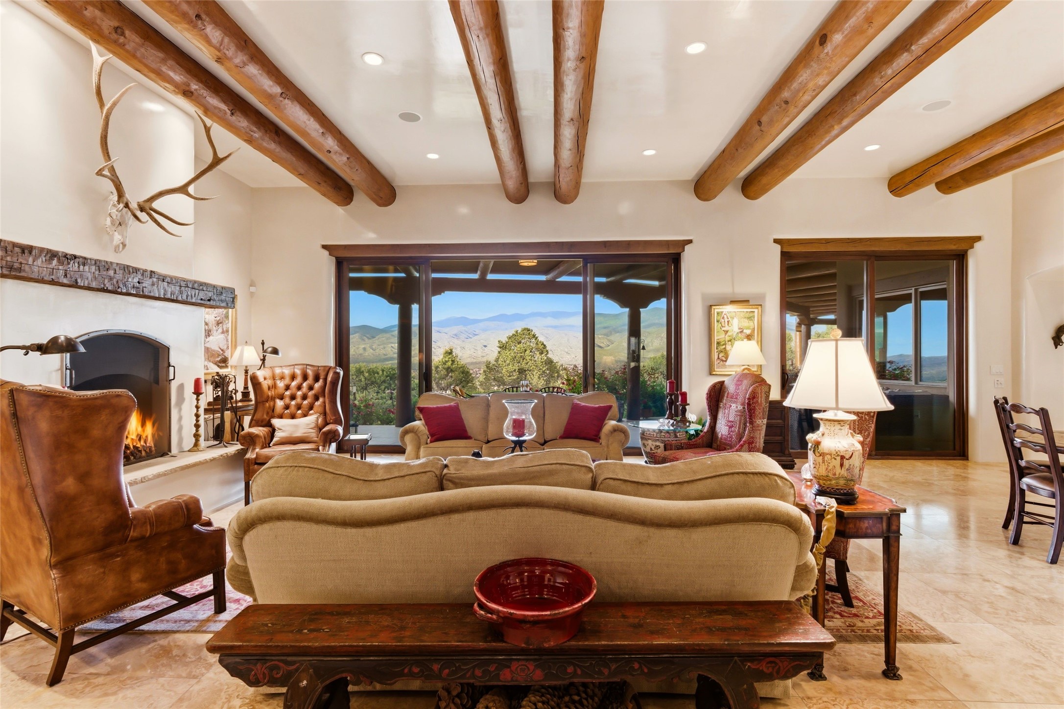 42 San Juan Ranch Road Santa Fe, NM 87506 - Photo 3 of 49 Spacious Living Room with fireplace flows seamlessly to outdoor Portal