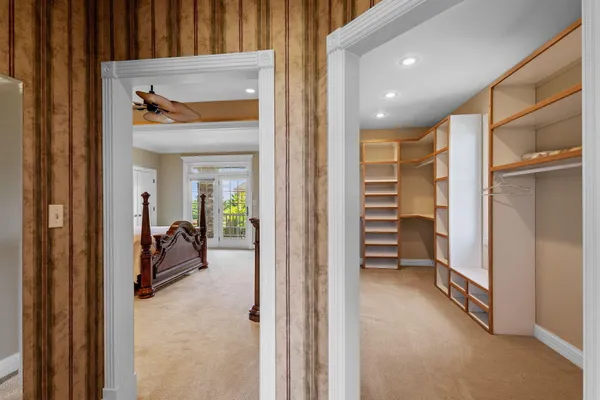 a view of a hallway with furniture and a window