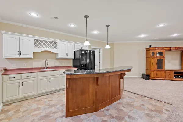 a kitchen with stainless steel appliances granite countertop a sink a stove and a refrigerator