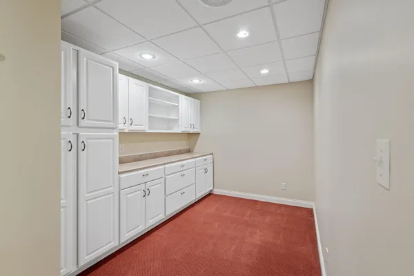 a room with white cabinets and sink