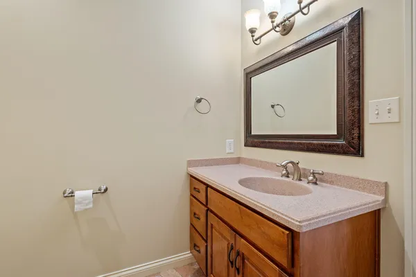 a bathroom with a sink vanity and a mirror