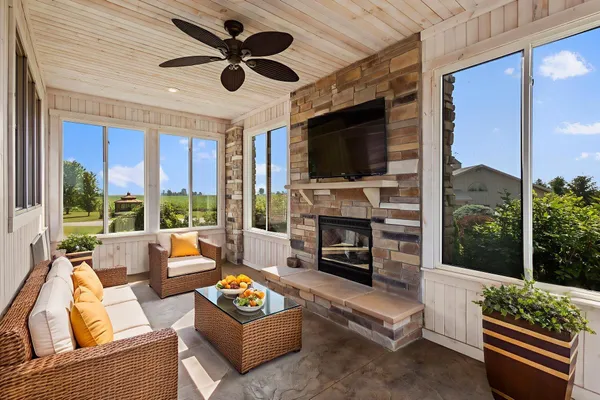 a living room with furniture a fireplace and a flat screen tv