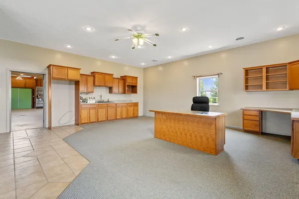 a large living room with stainless steel appliances kitchen island granite countertop furniture and a livingroom view