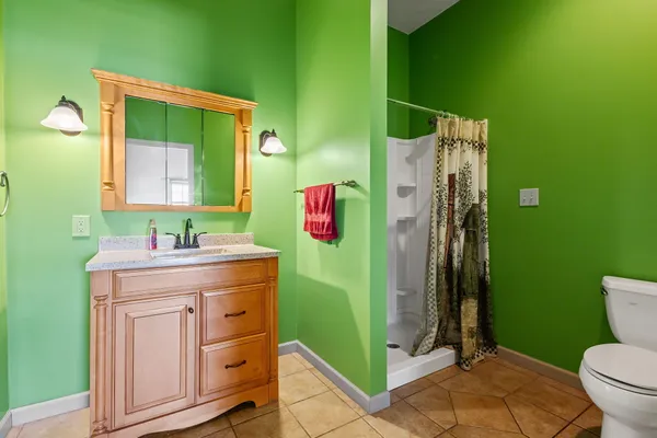 a bathroom with a sink mirror toilet and shower