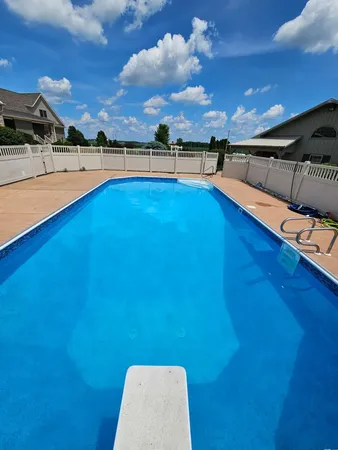a view of a swimming pool and an outdoor seating