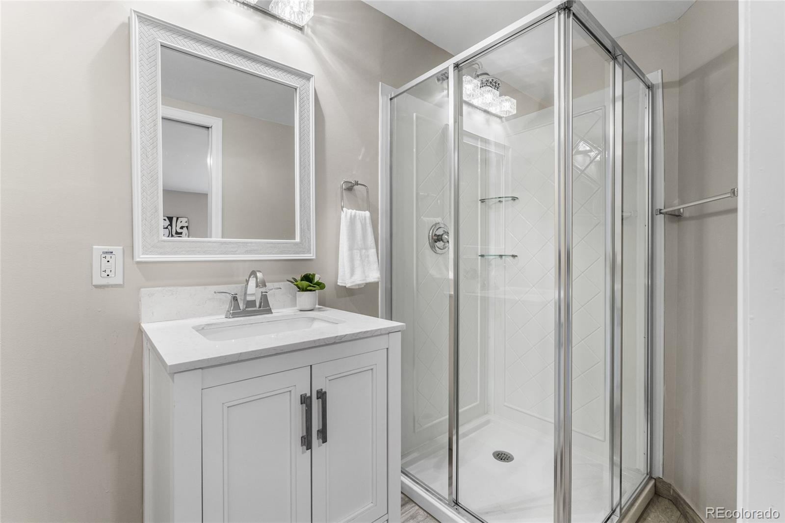 2259 Depew Street Edgewater, CO 80214 - Photo 23 of 46 a bathroom with a shower sink vanity and mirror
