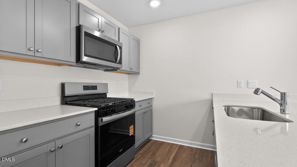 28 Red Clover Drive Angier, NC 27501 - Photo 11 of 41 a kitchen with granite countertop a sink and a stove top oven