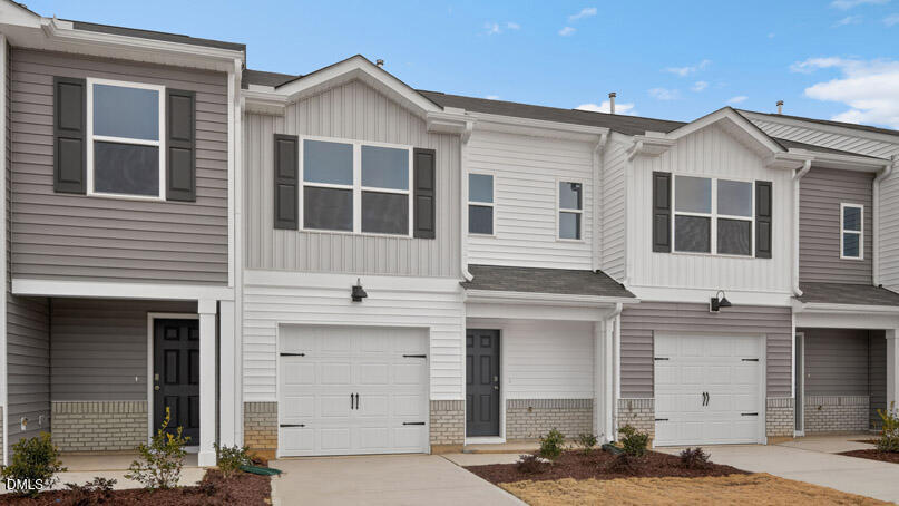 28 Red Clover Drive Angier, NC 27501 - Photo 2 of 41 a front view of a house with a garage