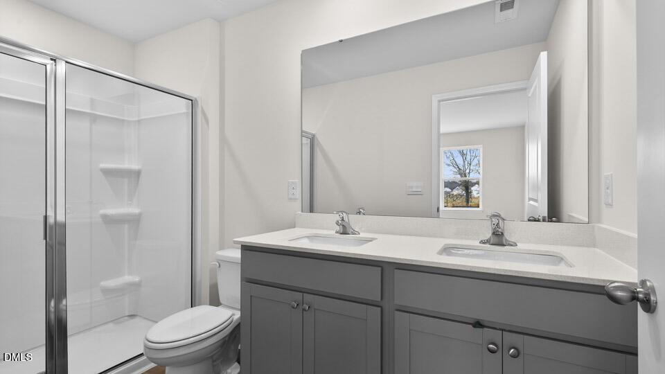 28 Red Clover Drive Angier, NC 27501 - Photo 23 of 41 a bathroom with a sink toilet vanity and shower