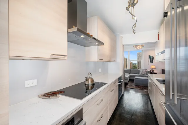 a kitchen with stainless steel appliances a sink a stove and a refrigerator
